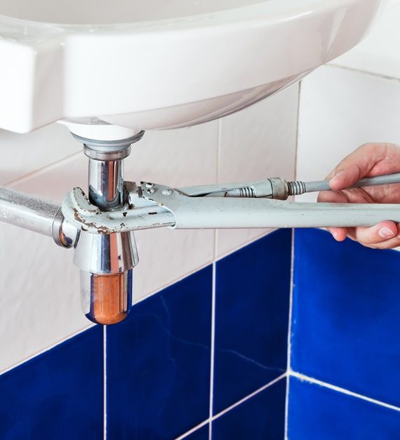 Plumber Repairing Sink — Murphy Plumbing In Lake Macquarie, NSW